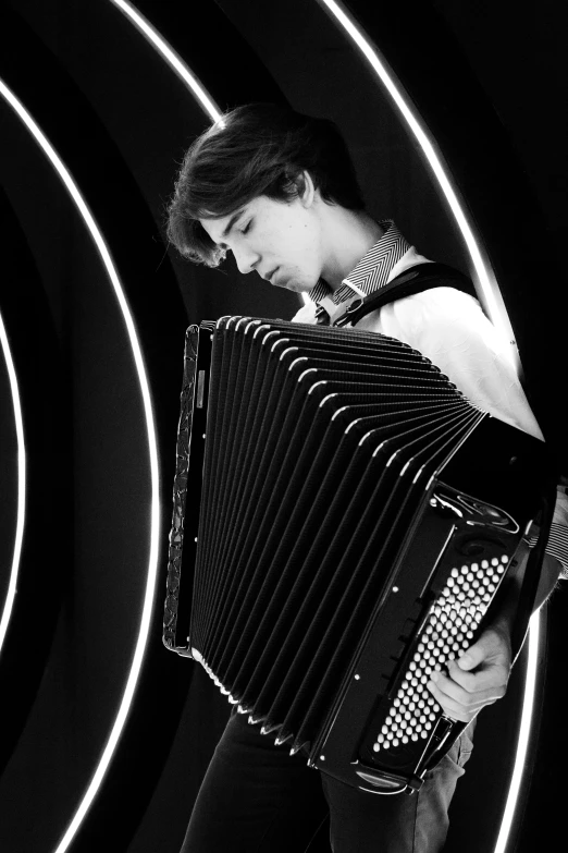 a woman holding an accordion while standing next to some circles