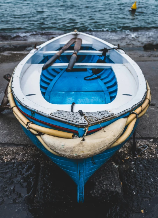 a blue and white boat with an orange stripe