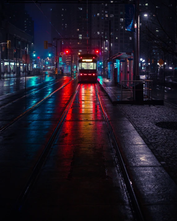 the trolley on the street is stopped at night