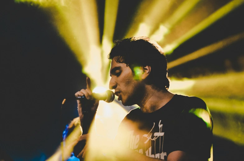 a man that is standing in front of a microphone