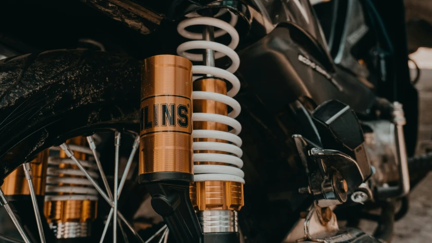 a close up of a bicycle with yellow springs