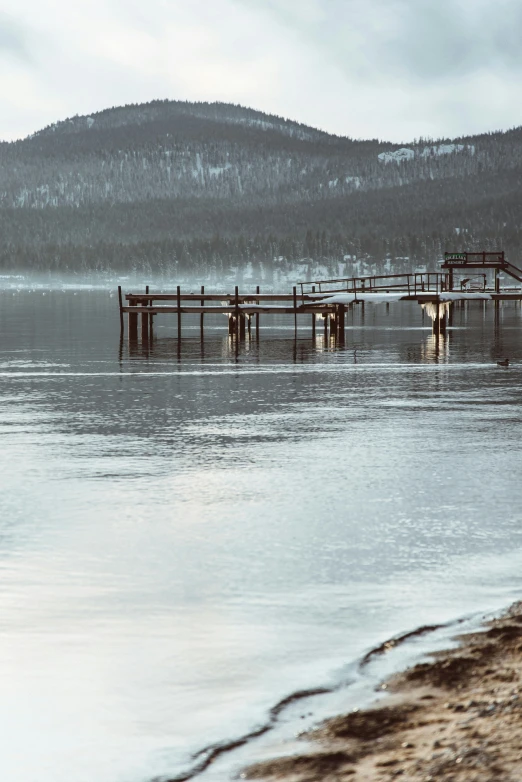 a pier sits out in the middle of a lake