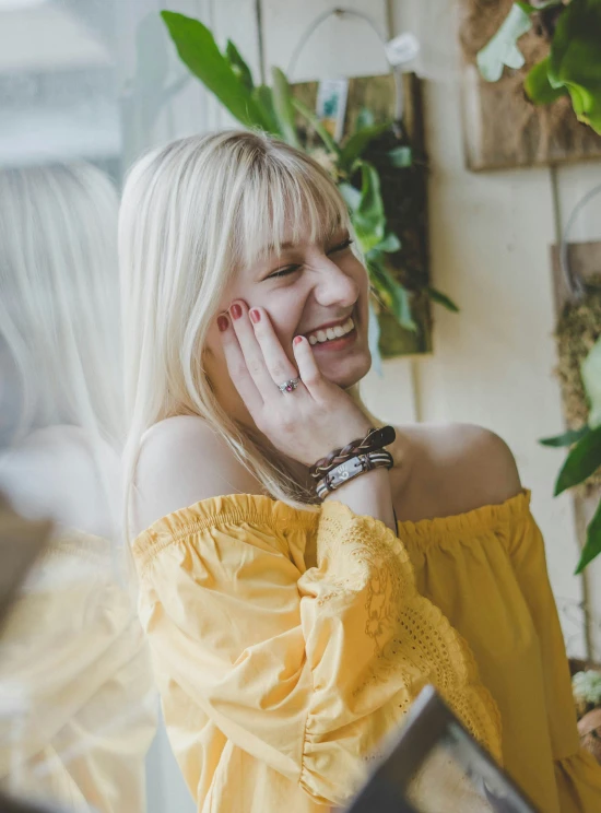 woman smiling at soing while leaning on her head