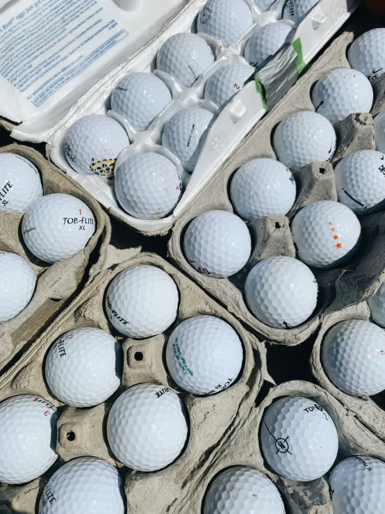 many dozens of golf balls are in cases