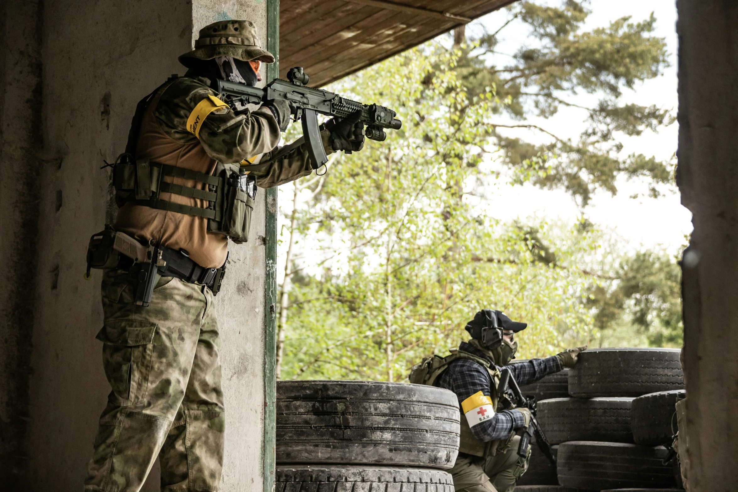 a couple of men holding guns and aiming at soing