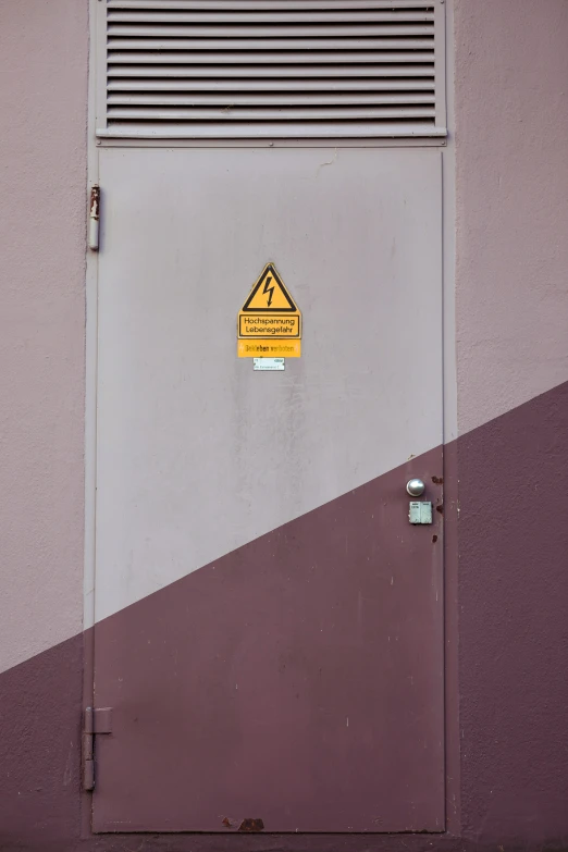 the side door of an office building with a sign indicating to use an elevator