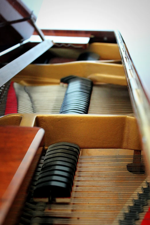 the side of an antique grand piano with three keys