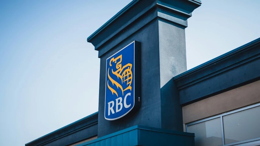 an blue sign that says rccc sitting on the side of a building