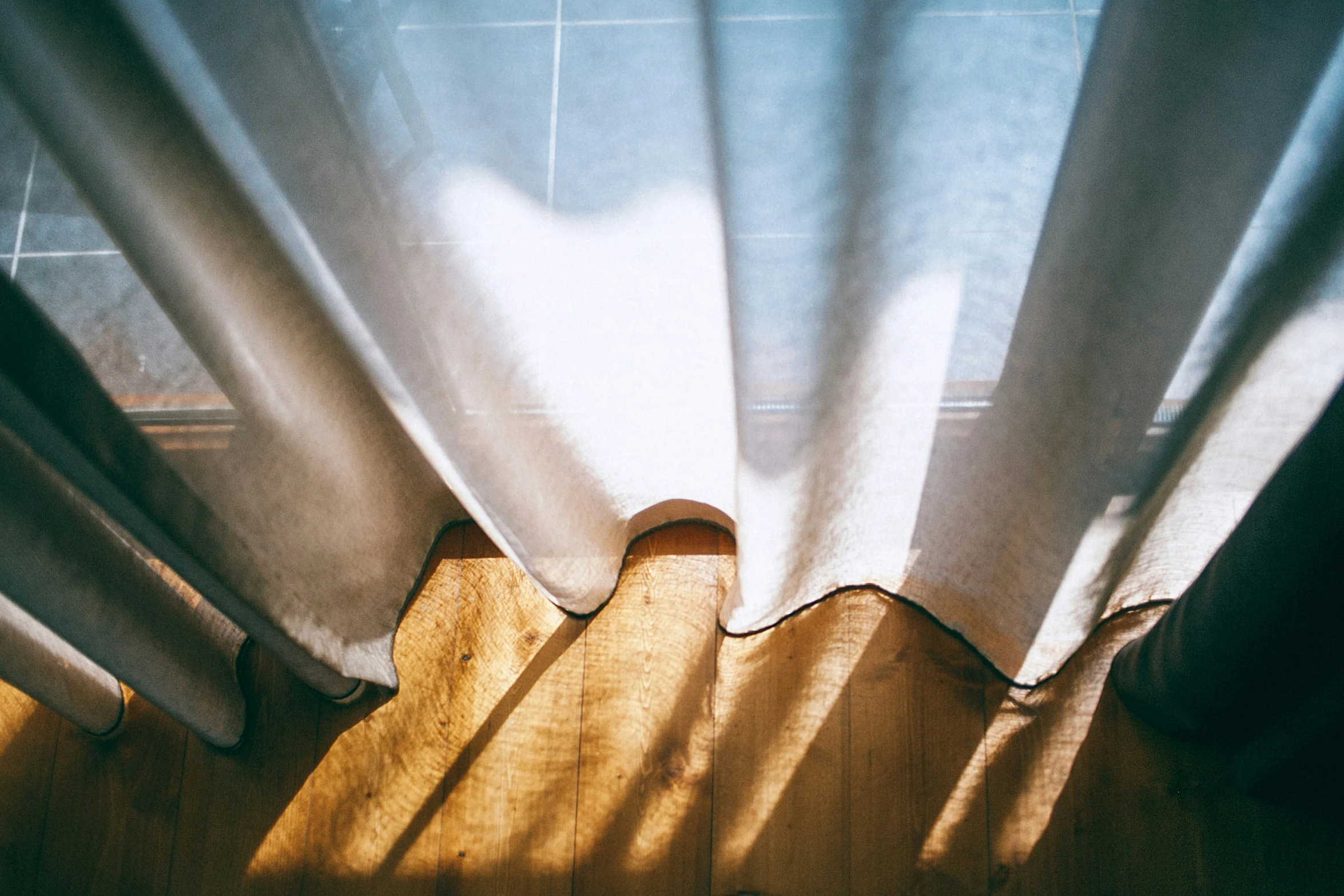 the blinds on a curtain hang open and are visible