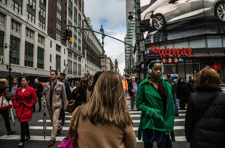 people are walking in the middle of a crowded street