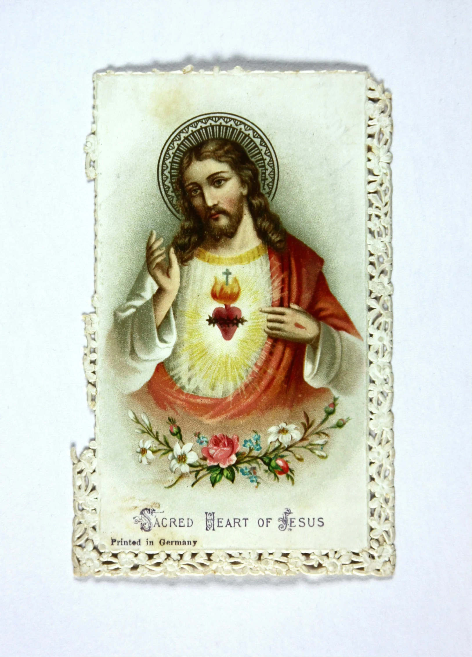 an antique card with the image of jesus in white