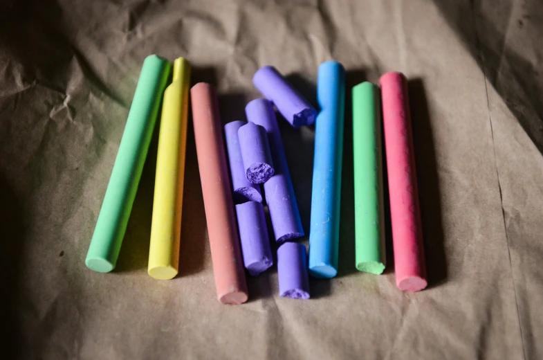 there are several colorful rolled up crayons on the sheet