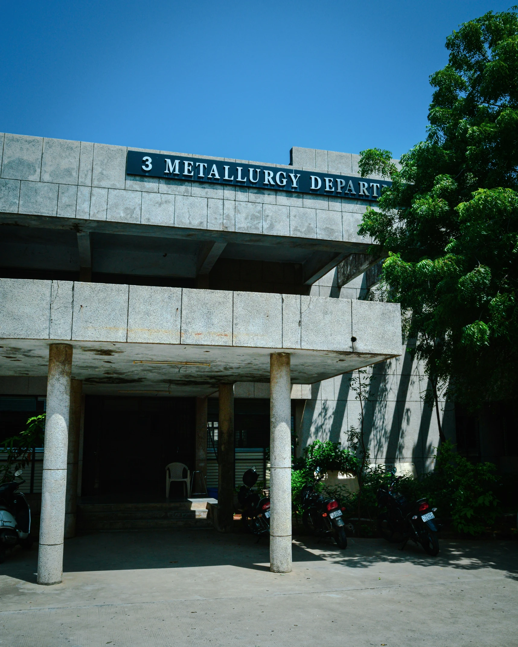 a gray building with three pillars and the number 3 headquarters sign above