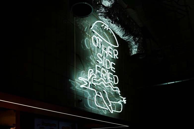 a neon sign is seen in the dark