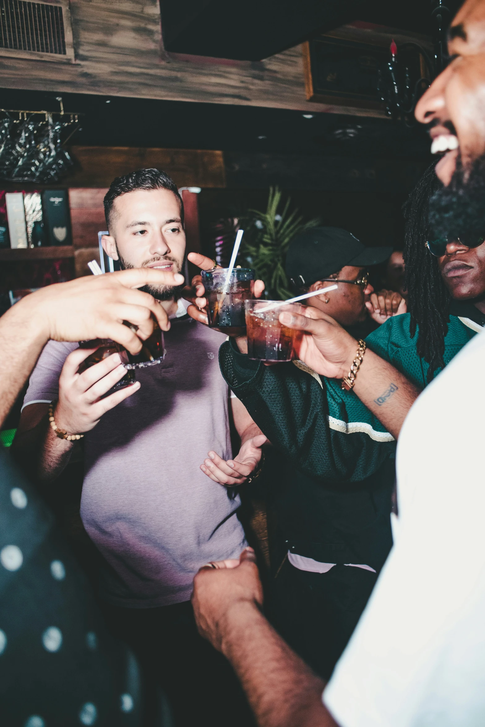 a group of friends toasting and having drinks together