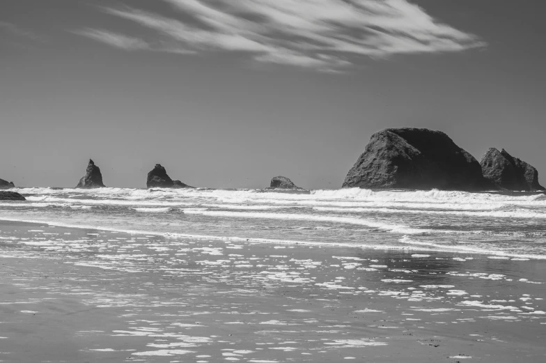 a sandy beach with waves coming in