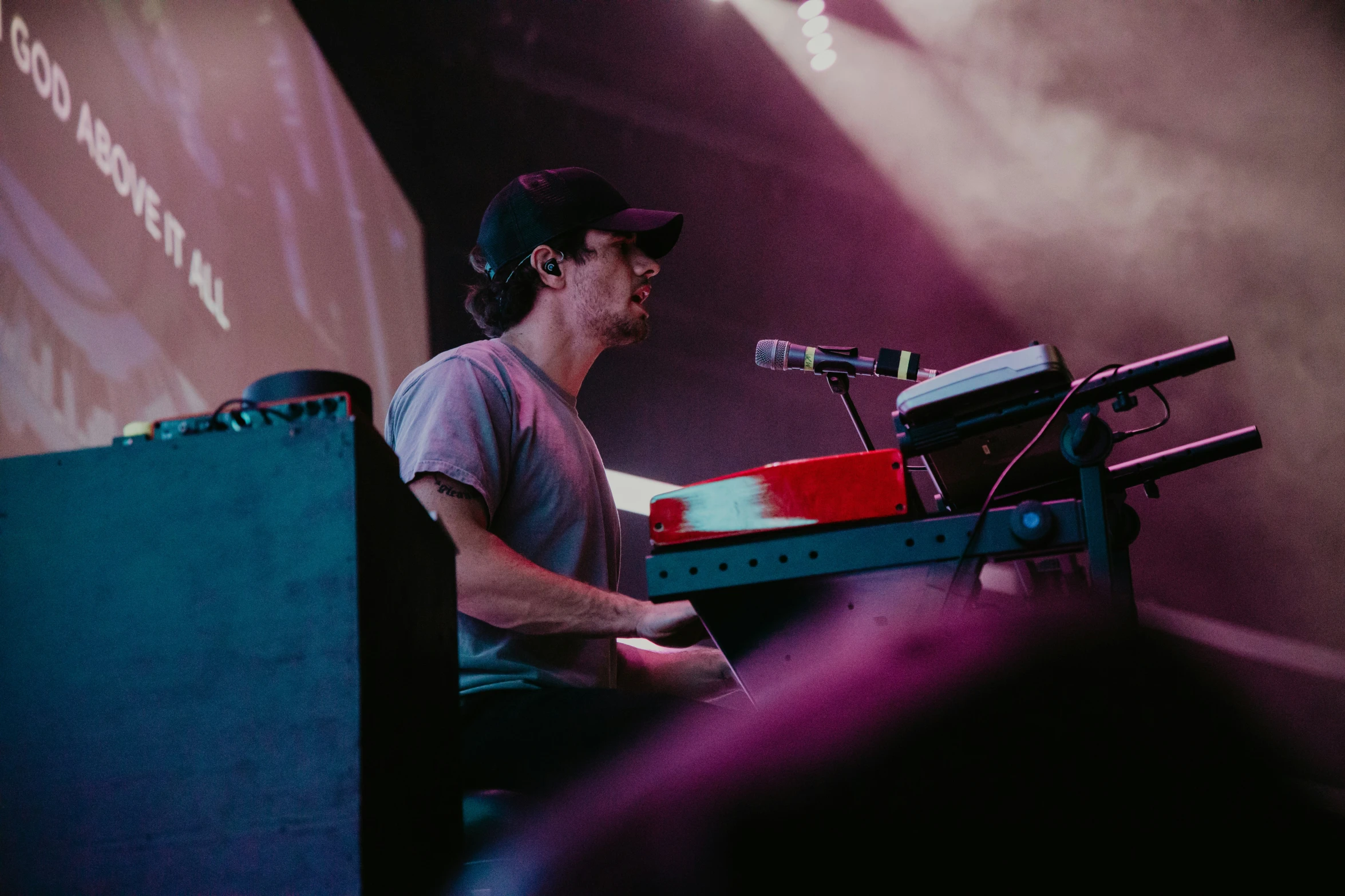 a man sitting in front of a keyboard on stage