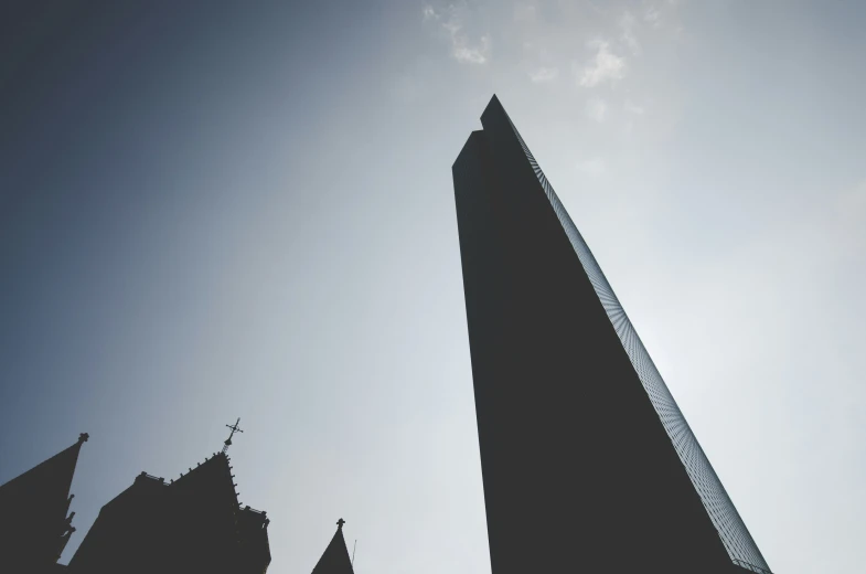 the top part of a large building, silhouetted by the sun