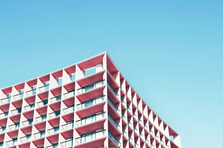 the building has red latticed balconies on its side