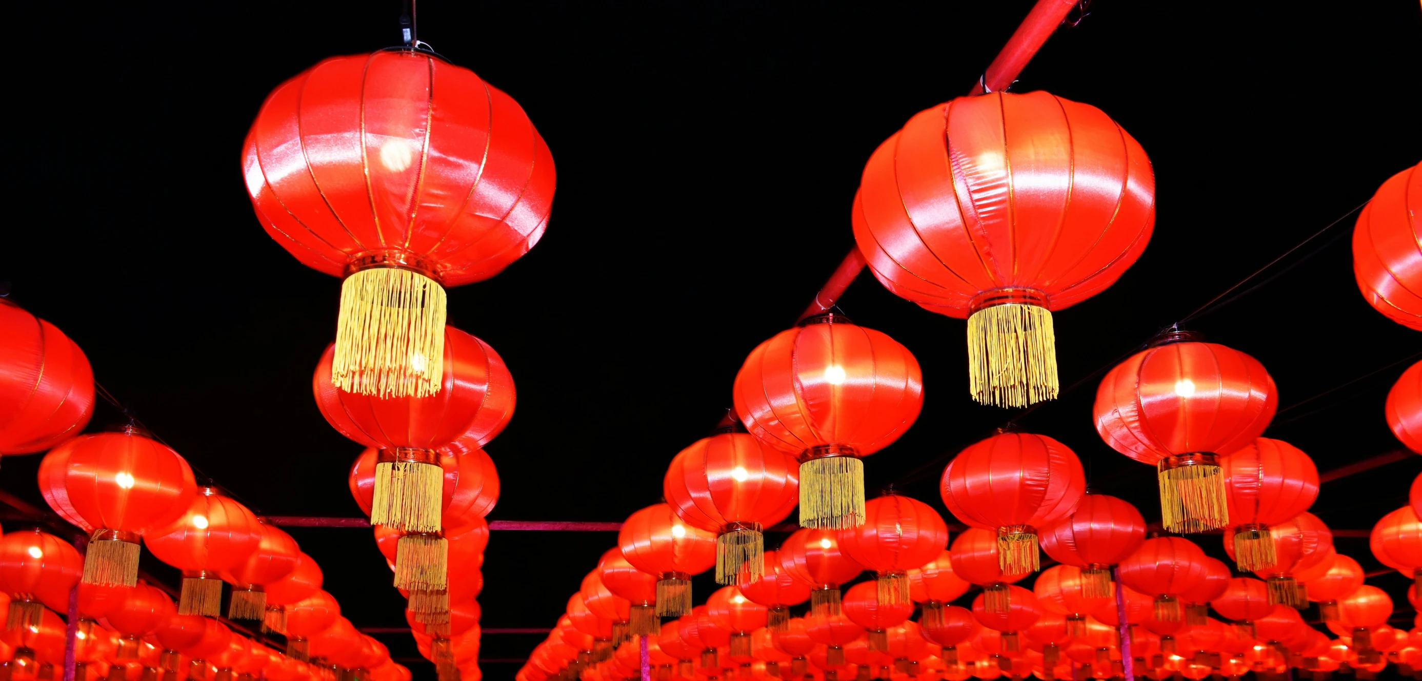 rows of red lanterns in front of black sky