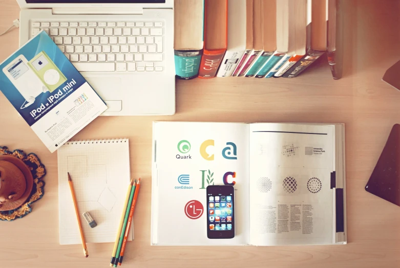 an open notebook sitting on top of a wooden desk