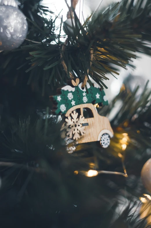 a wooden ornament on top of a christmas tree