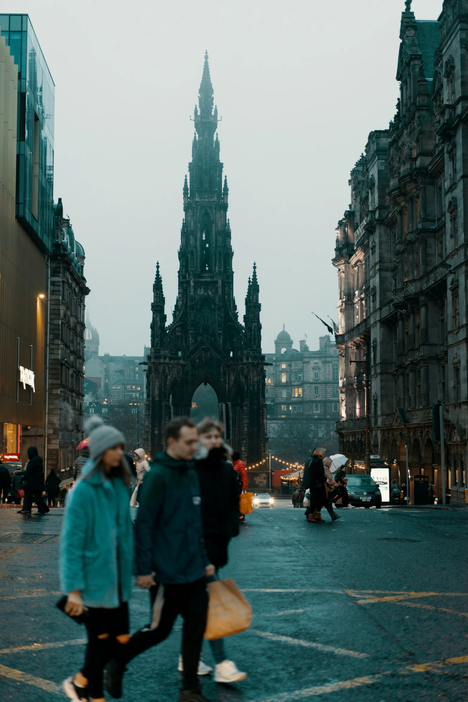 a couple of people walking across a city street