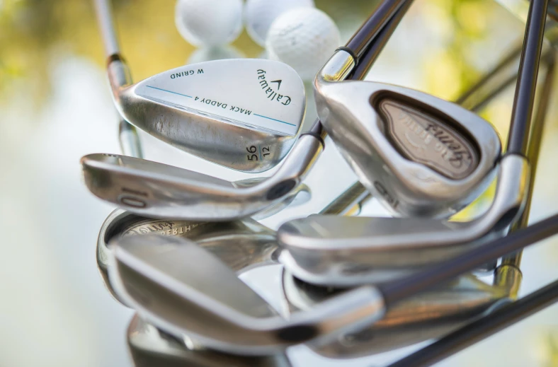 a bunch of golf irons are on display