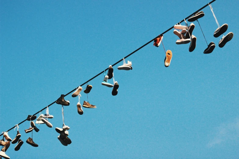 a group of shoes hanging out to dry