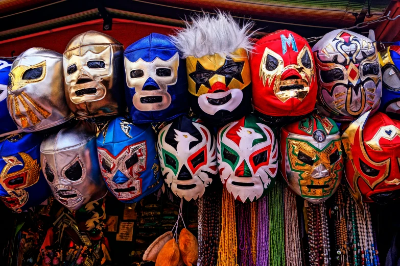 rows of colorful masks are in line and hanging on the wall