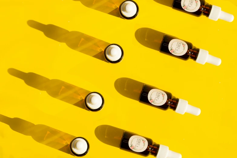 several medicine bottles on a table with some light coming through them