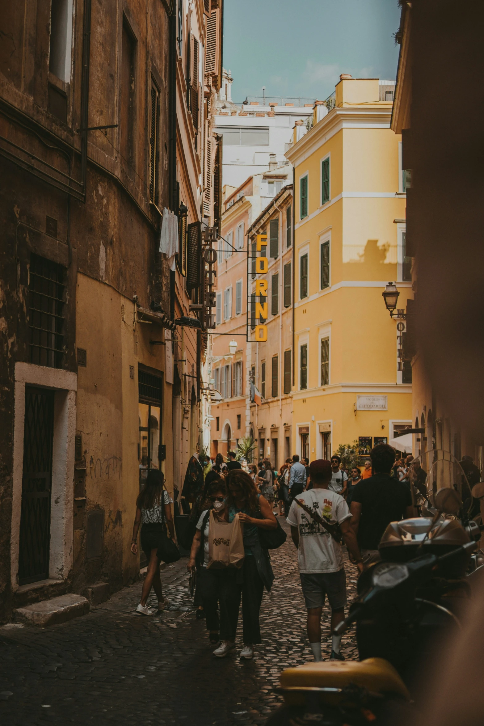 several people walking down the street in old city