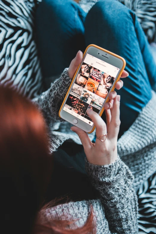 a woman using a cell phone on a bed