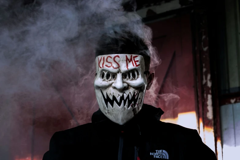 a man wearing a mask with writing on it