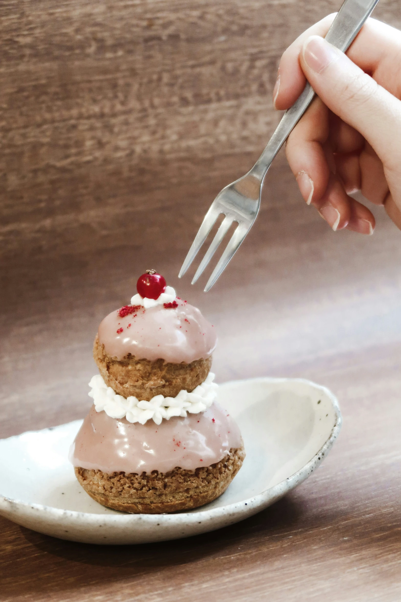 a person is placing icing on a desert