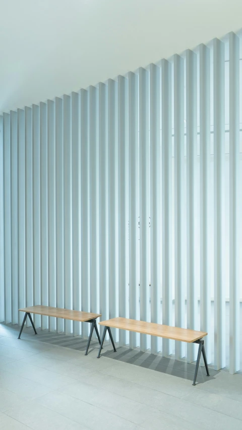 the benches are lined up against a wall with corrugated panels