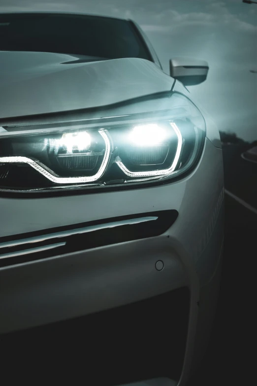 the headlights and front bumper lights of a silver car