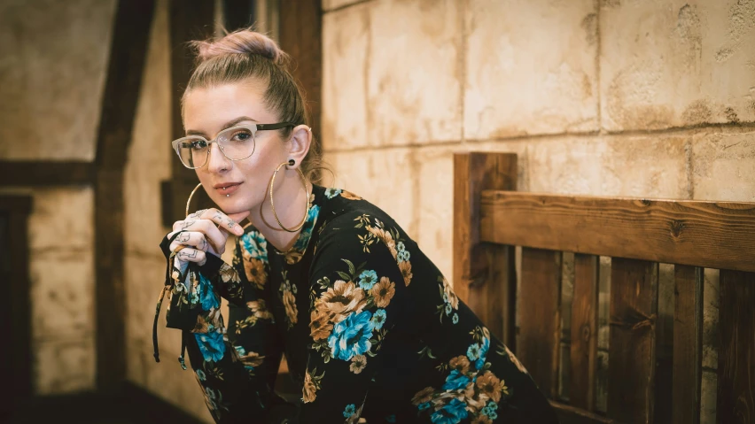 a woman wearing glasses leans her hands on her hips