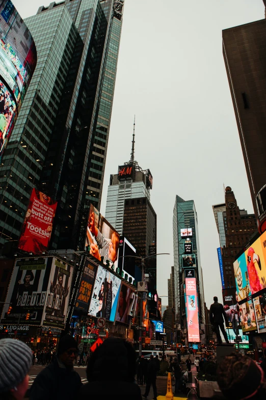 people in the city walking around in times square