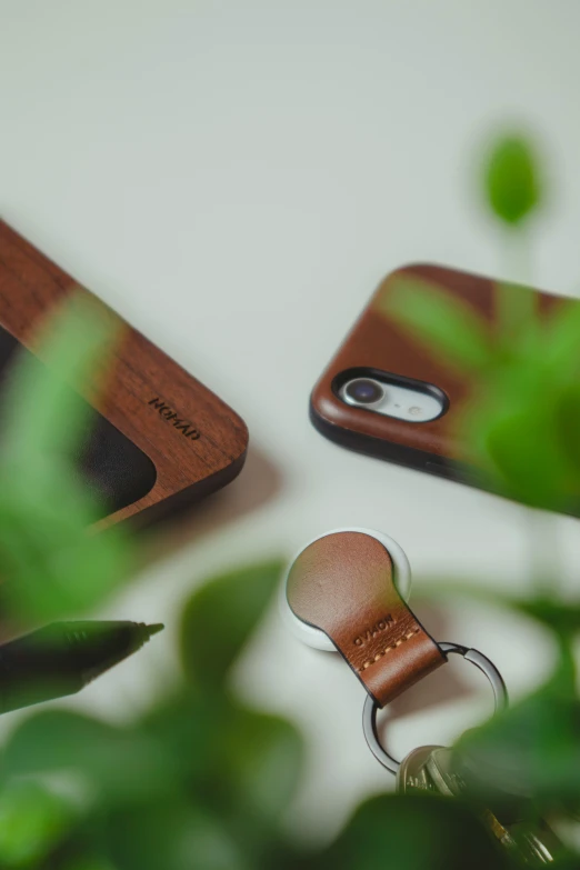 a pair of wooden cell phones sitting next to a keychain