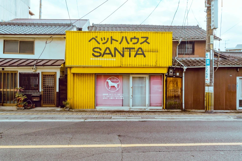 an old chinese style yellow building with a black sign