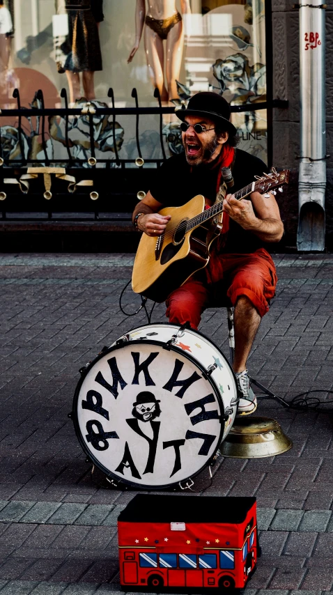 a man sitting on a box with a guitar