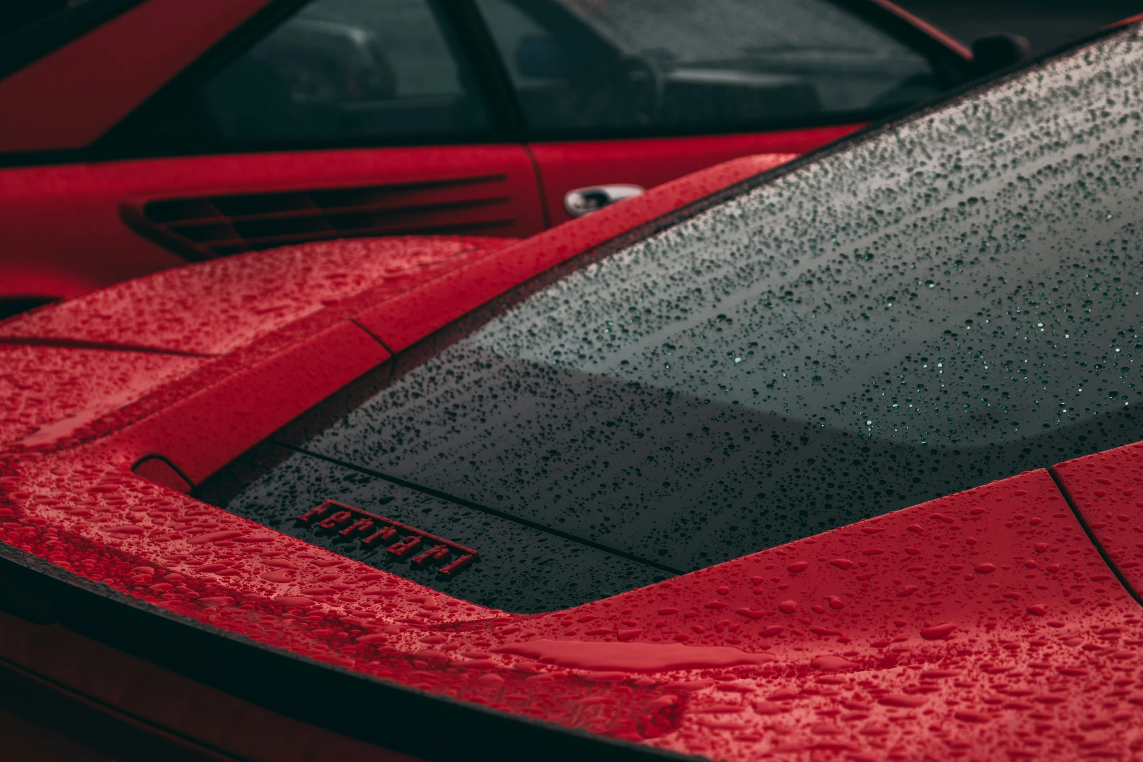 the rear end of a car with rain drops