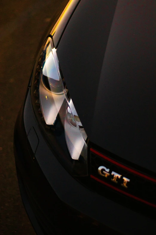 closeup of shiny metallic logo on black car