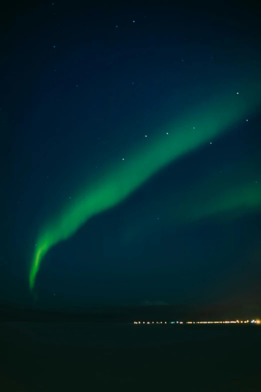 a bright green glow streaky light over a lake