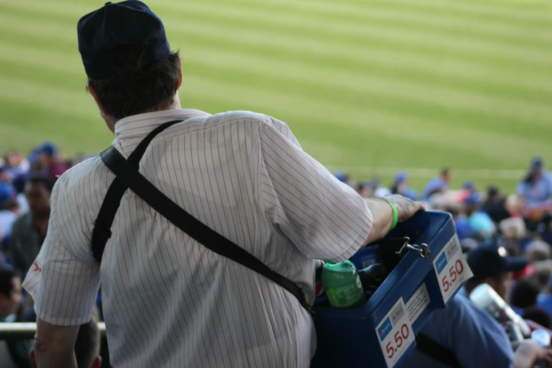 a baseball player with his suitcase and a hat on his back