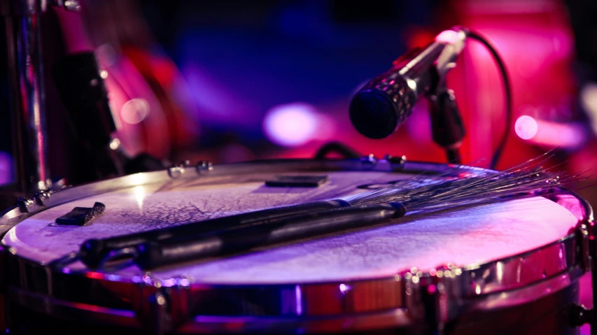 a recording drum sits on display with microphones attached