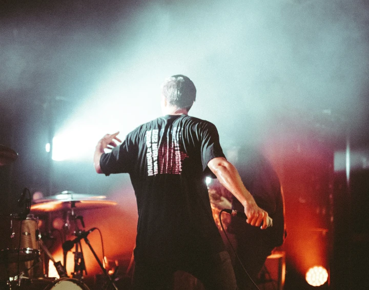 a person standing in front of a microphone on stage