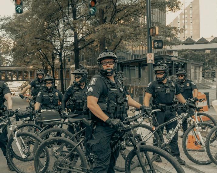 several police officers on bicycles in the middle of a street