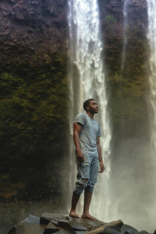 man standing in front of two waterfalls with no pants